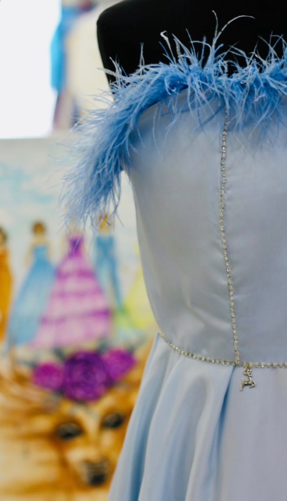 Finished blue satin dress with feathers